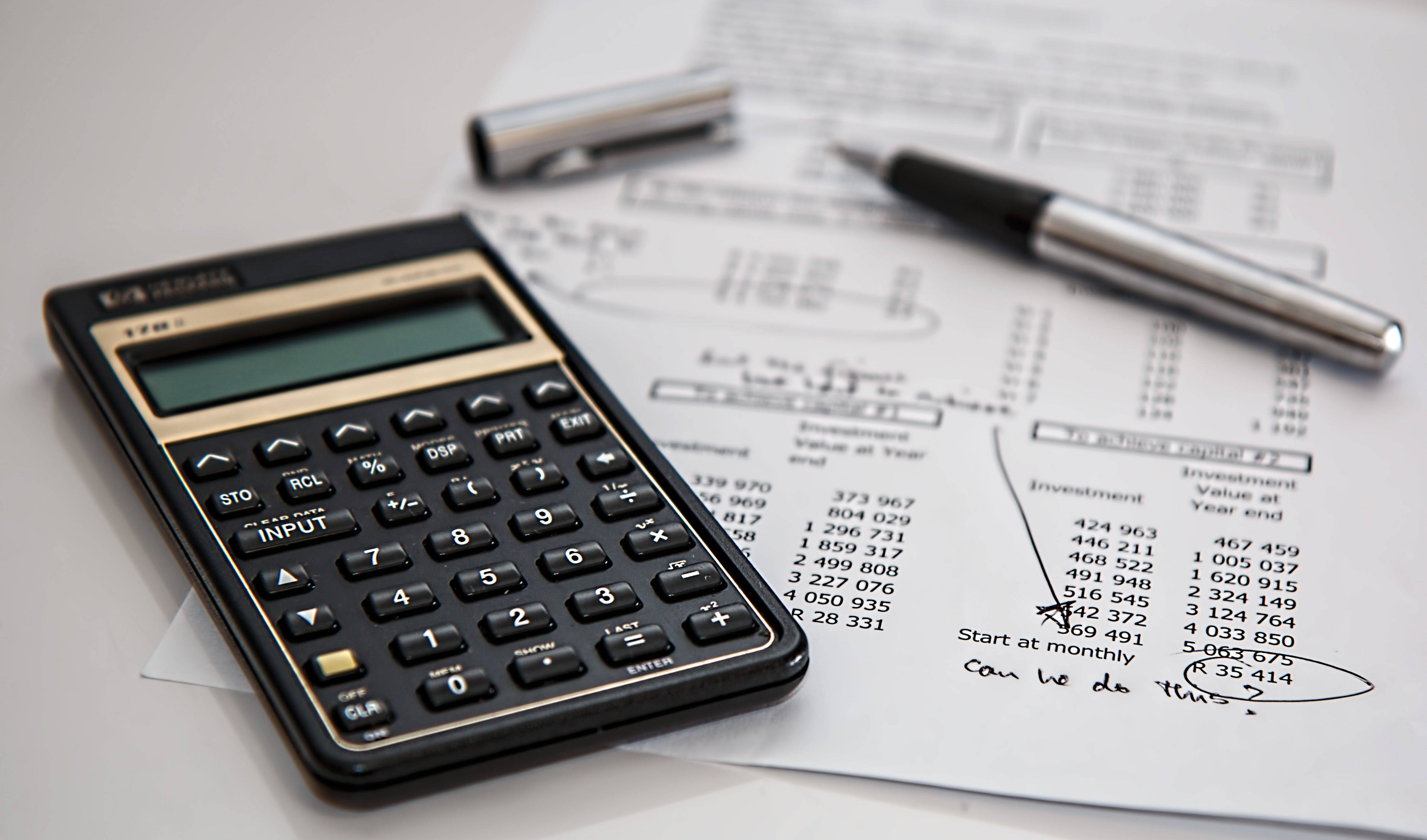 A calculator on top of a budget spreadsheet for MVP costing